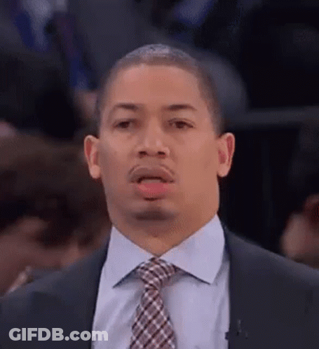 A Man In A Suit And Tie Making A Funny Face . GIF