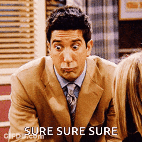 A Man In A Suit And Tie Making A Funny Face With The Words Sure Sure Sure Behind Him GIF