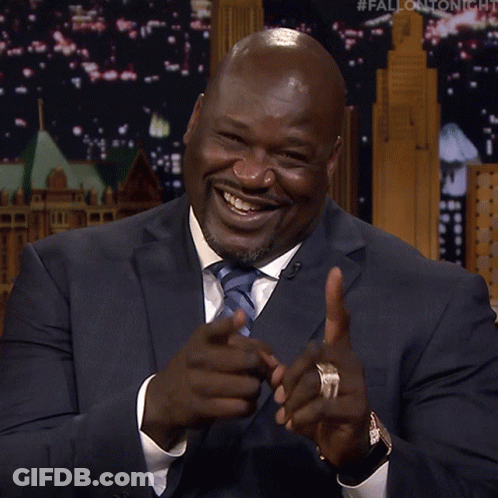 A Man In A Suit And Tie Pointing At The Camera GIF