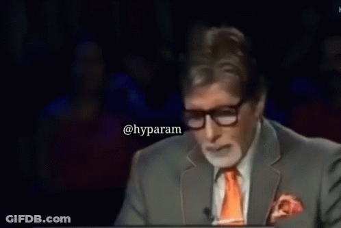 A Man In A Suit And Tie Says 7 Crore On A Screen GIF