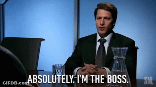 A Man In A Suit And Tie Says Absolutely I 'M The Boss While Sitting At A Table GIF