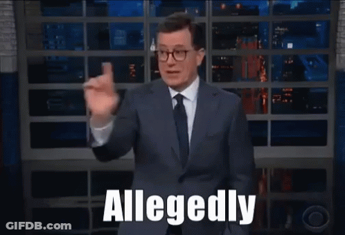 A Man In A Suit And Tie Says Allegedly While Waving GIF