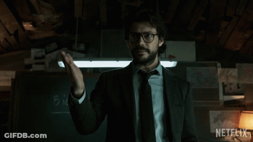 A Man In A Suit And Tie Says Bien In Front Of A Chalkboard GIF