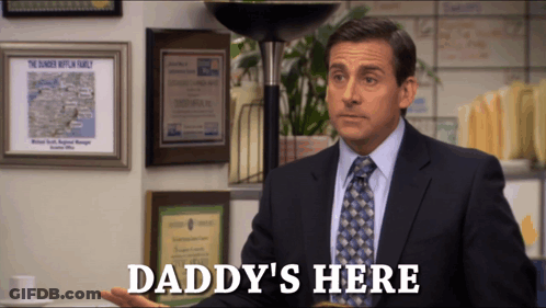 A Man In A Suit And Tie Says " Daddy 'S Here " In Front Of A Lamp GIF