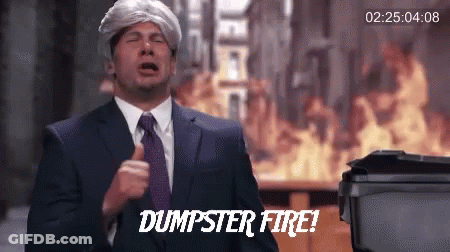 A Man In A Suit And Tie Says Dumpster Fire In Front Of A Fire GIF