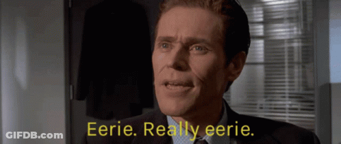 A Man In A Suit And Tie Says Eerie GIF