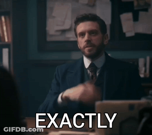 A Man In A Suit And Tie Says Exactly In Front Of A Laptop Computer GIF
