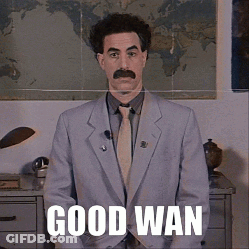 A Man In A Suit And Tie Says Good Wan In Front Of A World Map GIF