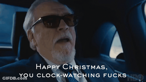 A Man In A Suit And Tie Says Happy Christmas GIF