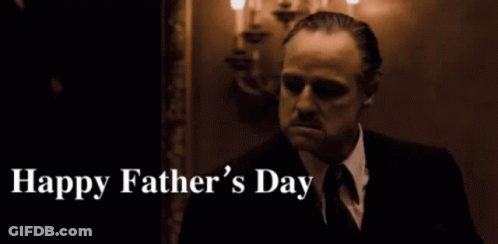 A Man In A Suit And Tie Says Happy Father 'S Day In A Dark Room GIF