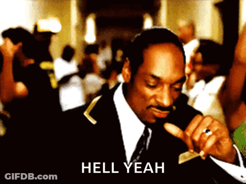 A Man In A Suit And Tie Says Hell Yeah In Front Of A Crowd GIF