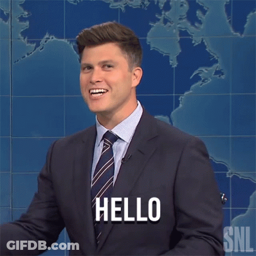 A Man In A Suit And Tie Says Hello In Front Of A Map GIF