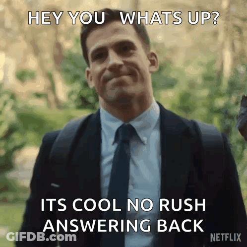 A Man In A Suit And Tie Says Hey You Whats Up GIF