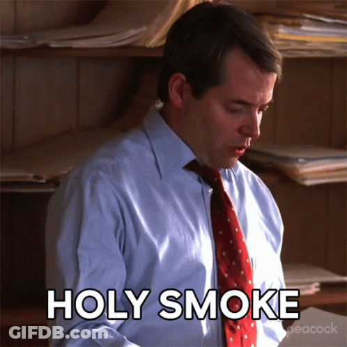 A Man In A Suit And Tie Says Holy Smoke GIF