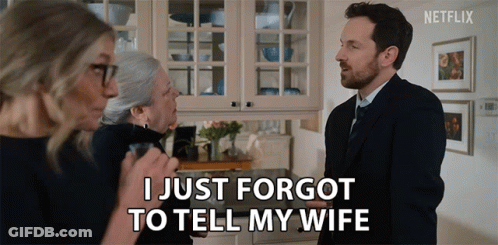A Man In A Suit And Tie Says I Just Forgot To Tell My Wife In Front Of Two Women GIF