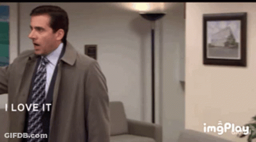 A Man In A Suit And Tie Says " I Love It " In A Living Room GIF