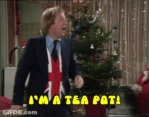 A Man In A Suit And Tie Says I 'M A Tea Pot In Front Of A Christmas Tree GIF