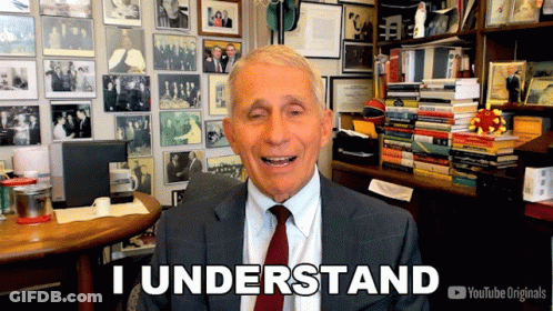 A Man In A Suit And Tie Says " I Understand " In Front Of A Wall Of Pictures GIF