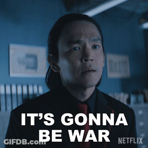 A Man In A Suit And Tie Says It 'S Gonna Be War On A Netflix Poster GIF