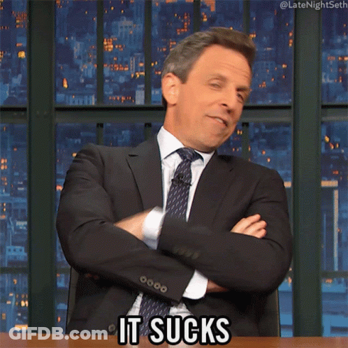 A Man In A Suit And Tie Says " It Sucks " With His Arms Crossed GIF