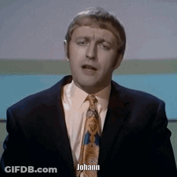 A Man In A Suit And Tie Says Johann In Front Of A Blue Background GIF
