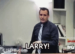 A Man In A Suit And Tie Says Larry In Front Of A Desk GIF