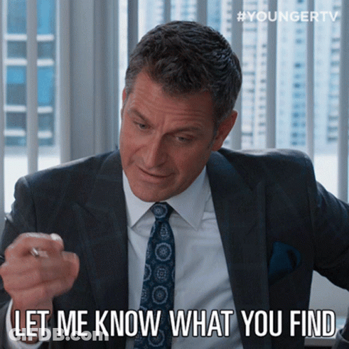 A Man In A Suit And Tie Says " Let Me Know What You Find " While Pointing At Something GIF