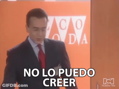 A Man In A Suit And Tie Says No Lo Puedo Creer In Front Of An Orange Wall GIF
