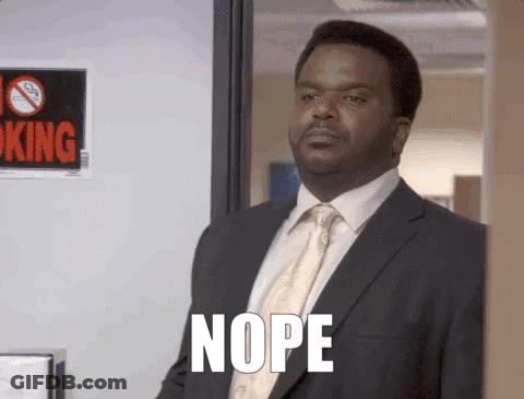 A Man In A Suit And Tie Says Nope In Front Of A No Smoking Sign . GIF