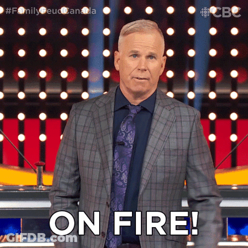 A Man In A Suit And Tie Says " On Fire " In Front Of A Crowd GIF