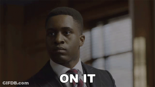 A Man In A Suit And Tie Says " On It " In Front Of A Window GIF