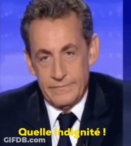 A Man In A Suit And Tie Says " Quella Indignite " In Yellow GIF
