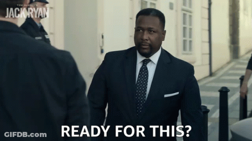 A Man In A Suit And Tie Says " Ready For This " As He Walks Down A Street GIF