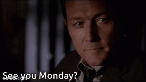 A Man In A Suit And Tie Says " See You Monday " In A Dark Room GIF