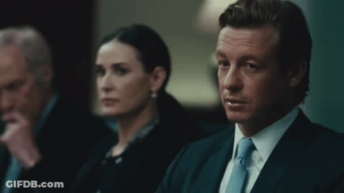 A Man In A Suit And Tie Says Sell It All In Front Of A Woman GIF
