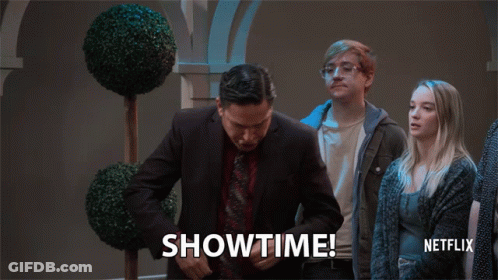A Man In A Suit And Tie Says Showtime In Front Of A Netflix Logo GIF