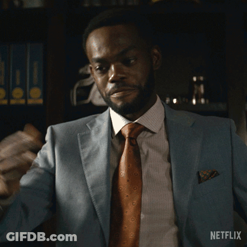 A Man In A Suit And Tie Says Sit Down In A Netflix Advertisement GIF