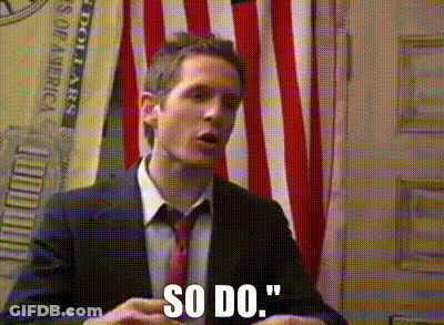 A Man In A Suit And Tie Says So Do In Front Of An American Flag GIF