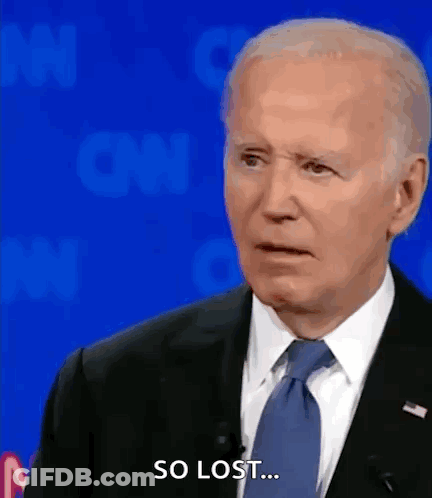 A Man In A Suit And Tie Says So Lost While Standing In Front Of A Blue Background . GIF