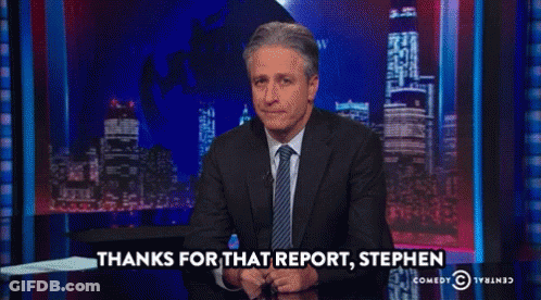 A Man In A Suit And Tie Says Thanks For That Report Stephen On A Comedy Central Show GIF