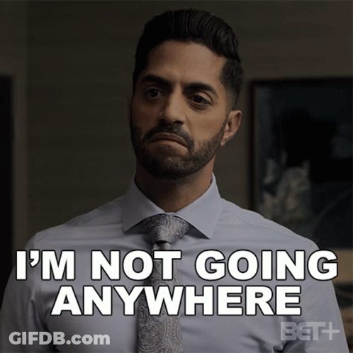 A Man In A Suit And Tie Says That He Is Not Going Anywhere GIF