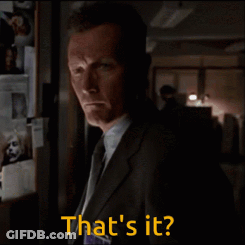 A Man In A Suit And Tie Says That 'S It In A Dark Room GIF