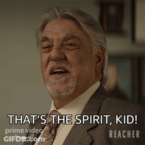A Man In A Suit And Tie Says That 'S The Spirit Kid Reacher GIF