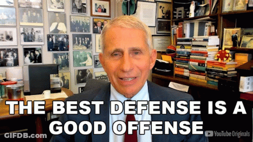 A Man In A Suit And Tie Says The Best Defense Is A Good Offense In Front Of A Wall Of Pictures GIF