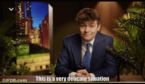 A Man In A Suit And Tie Says This Is A Very Delicate Situation In Front Of A Microphone GIF