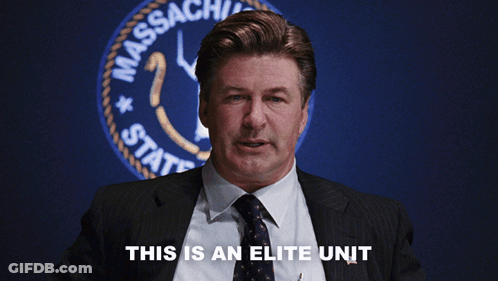 A Man In A Suit And Tie Says This Is An Elite Unit In Front Of A Massachusetts State Seal GIF