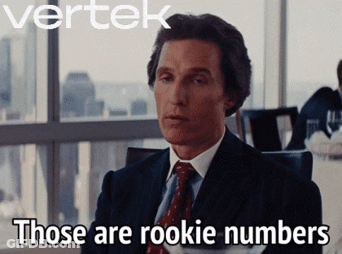 A Man In A Suit And Tie Says " Those Are Rookie Numbers " In Front Of A Window GIF