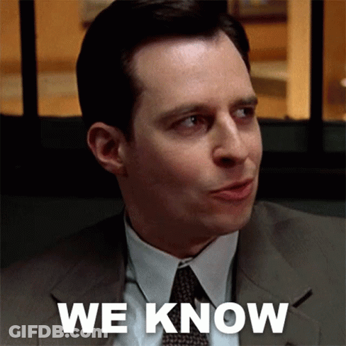 A Man In A Suit And Tie Says " We Know " In White Letters GIF