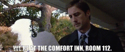 A Man In A Suit And Tie Says We 'Re At The Comfort Inn Room 112 .. GIF