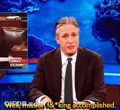 A Man In A Suit And Tie Says Well Mission F & King Accomplished In Front Of A Map Of The World GIF